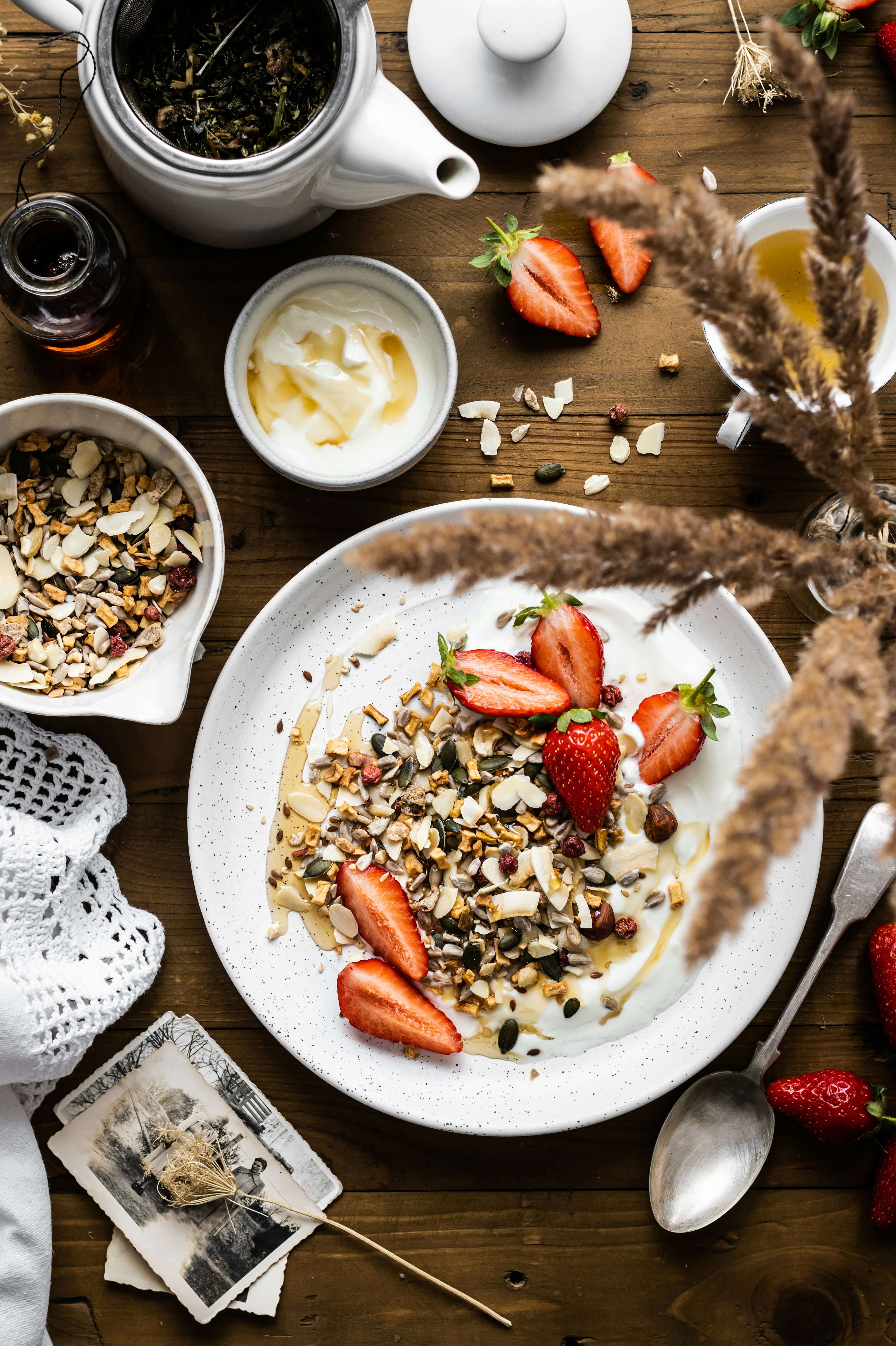 sliced strawberries and nuts on white ceramic plate